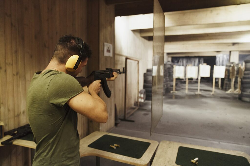 man-aiming-with-a-rifle-in-an-indoor-shooting-ran-min